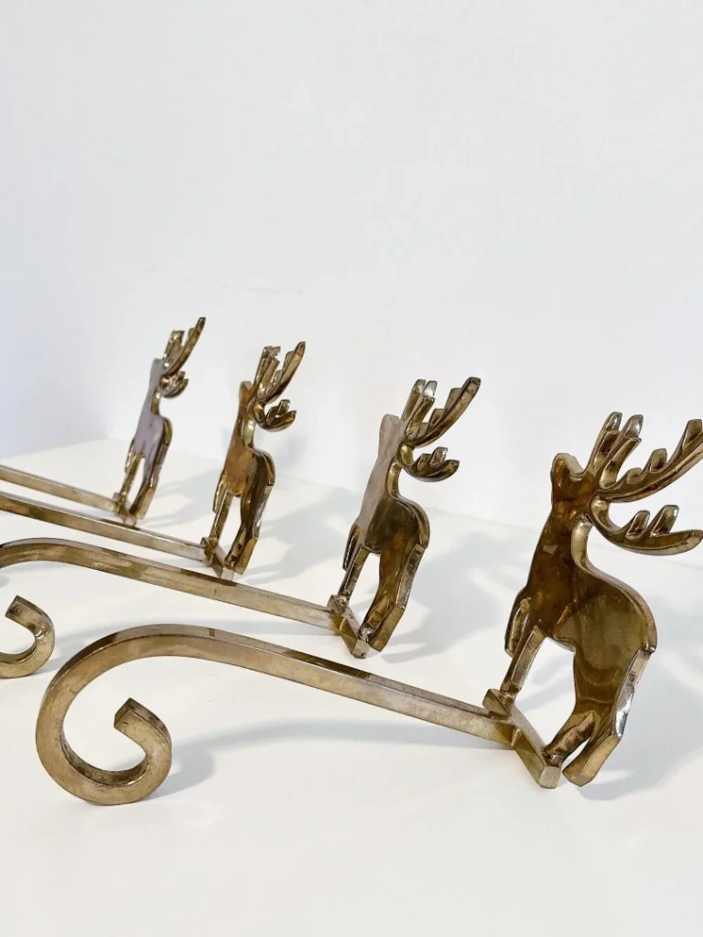 SET OF FOUR BRASS REINDEER MANTEL STOCKING HANGERS